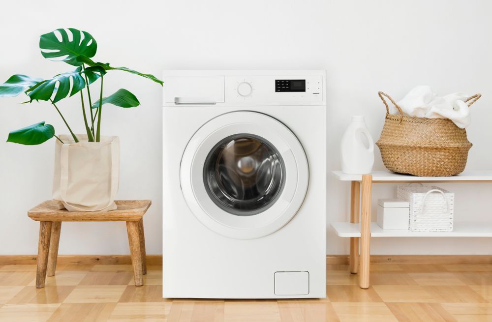 White Front-loading Washing Machine in a Bright Laundry Room — Tyrone Building Solutions in Anna Bay, NSW