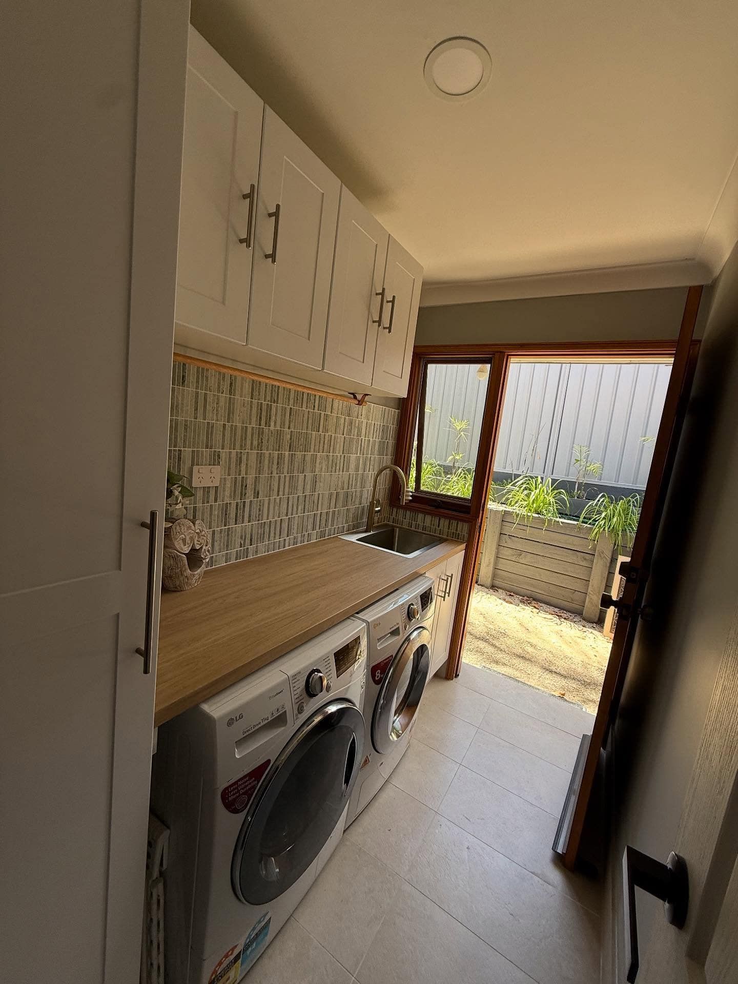 Narrow Laundry Nook With Stacked Washer-dryer — Tyrone Building Solutions in Anna Bay, NSW