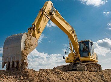 Excavator blue sky heavy machine construction site — Asphalt Service in West Bend, WI
