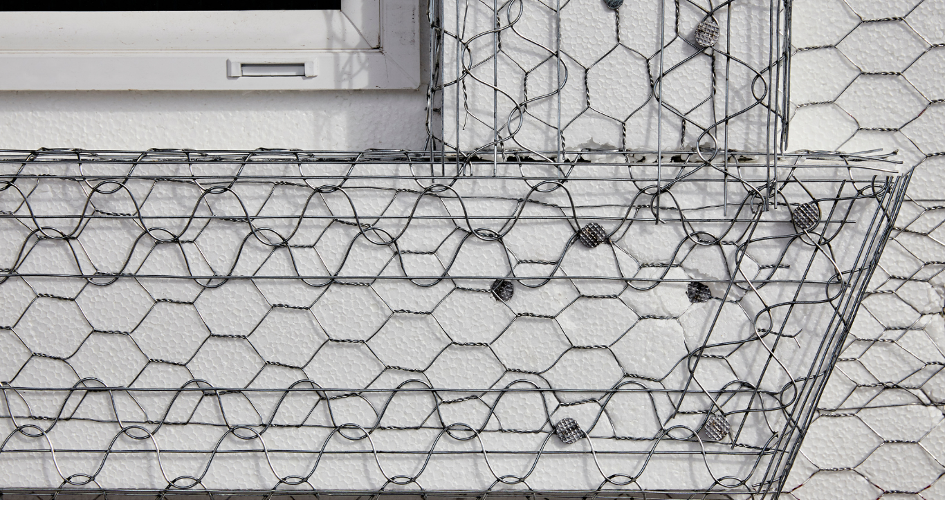 Metal lath surrounding window frame to