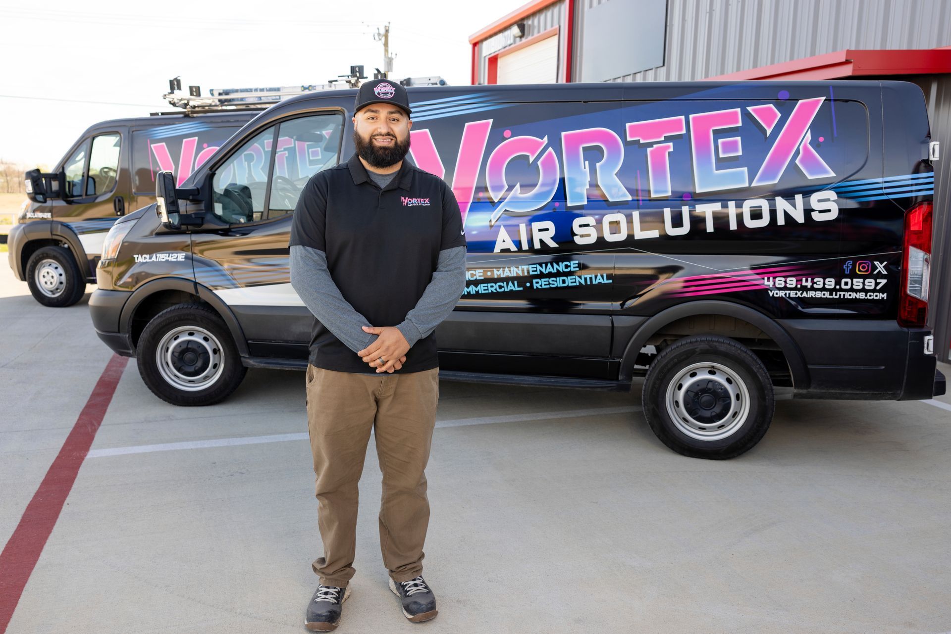 A hand holding a yellow digital thermometer that displays 69.4°F, in front of a white filter in a metal frame.