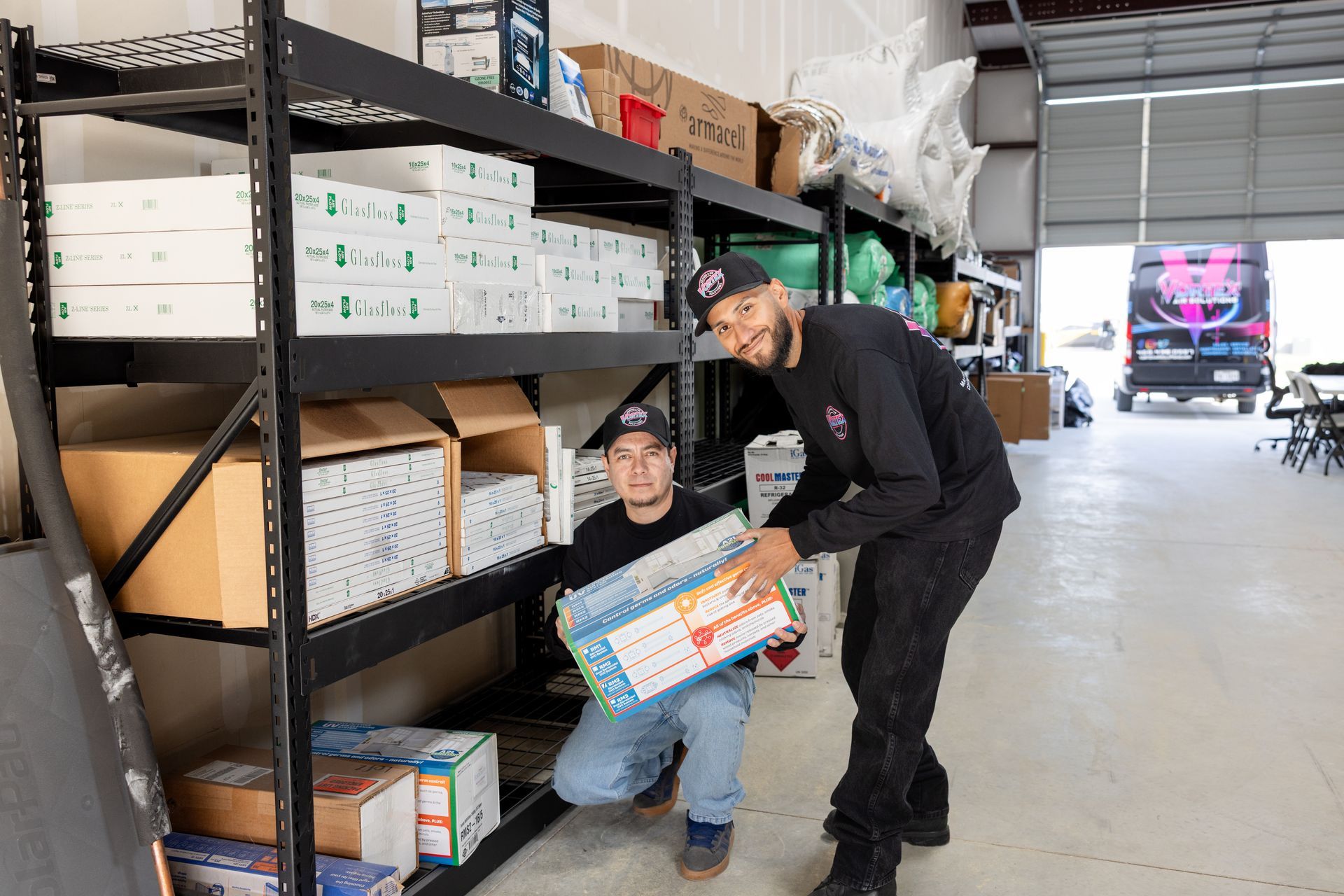 Modern living room with gray walls, large TV, white couch, and plant near window.