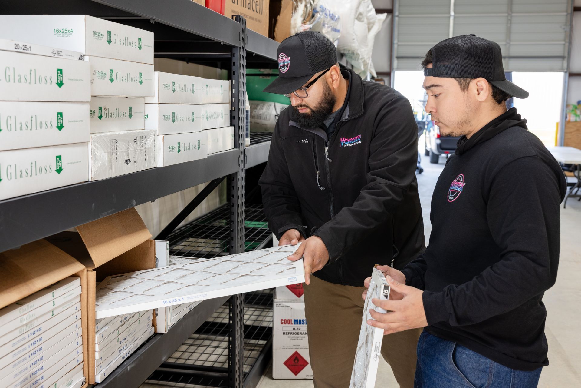 Person wearing a hat and black shirt with the logo 