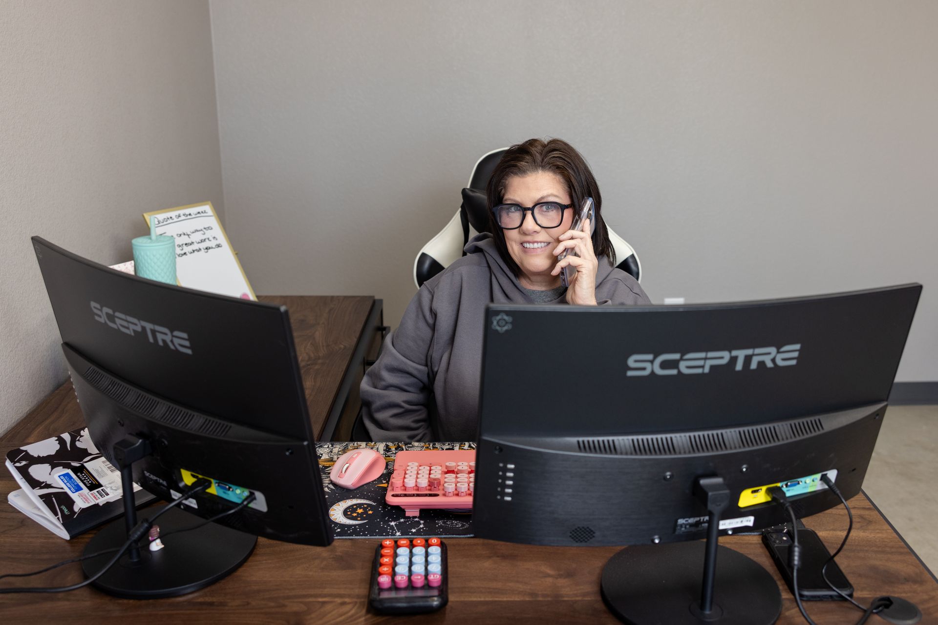 Family with a dog in a living room; the son on the father's shoulders; mother smiles.
