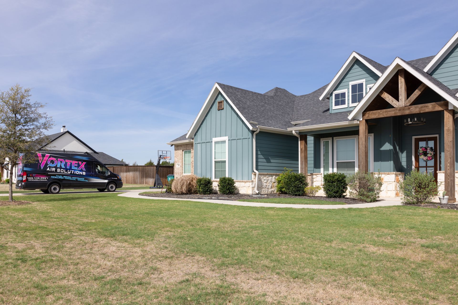 Golden retriever dog lying on a rug, with a couple relaxing on a couch in the background.