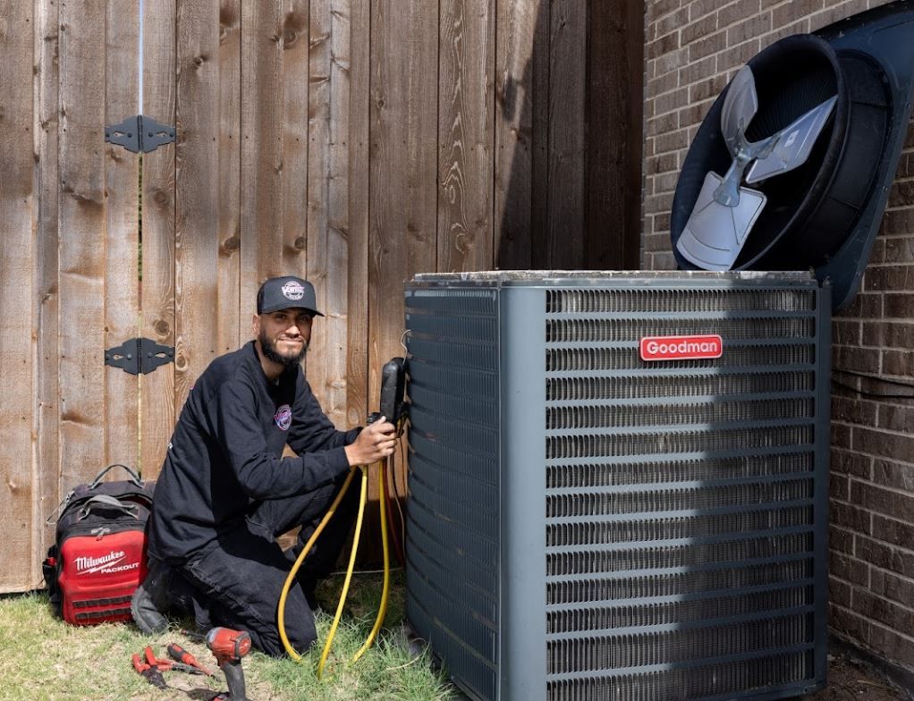 Family laughs together on a couch in a bright living room.