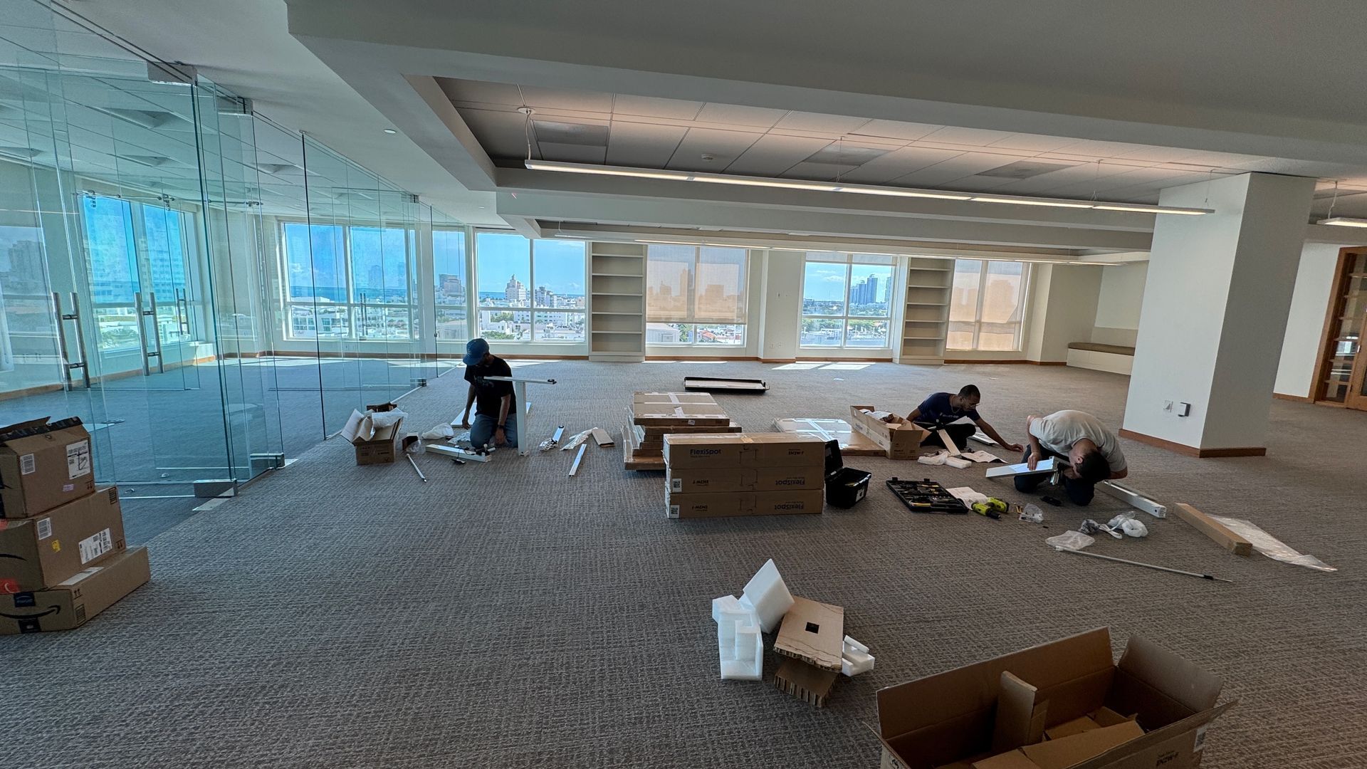 A large empty room with a lot of boxes on the floor.