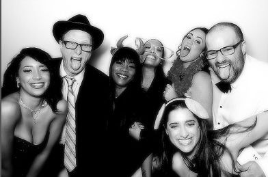 A group of people are posing for a picture in a photo booth.