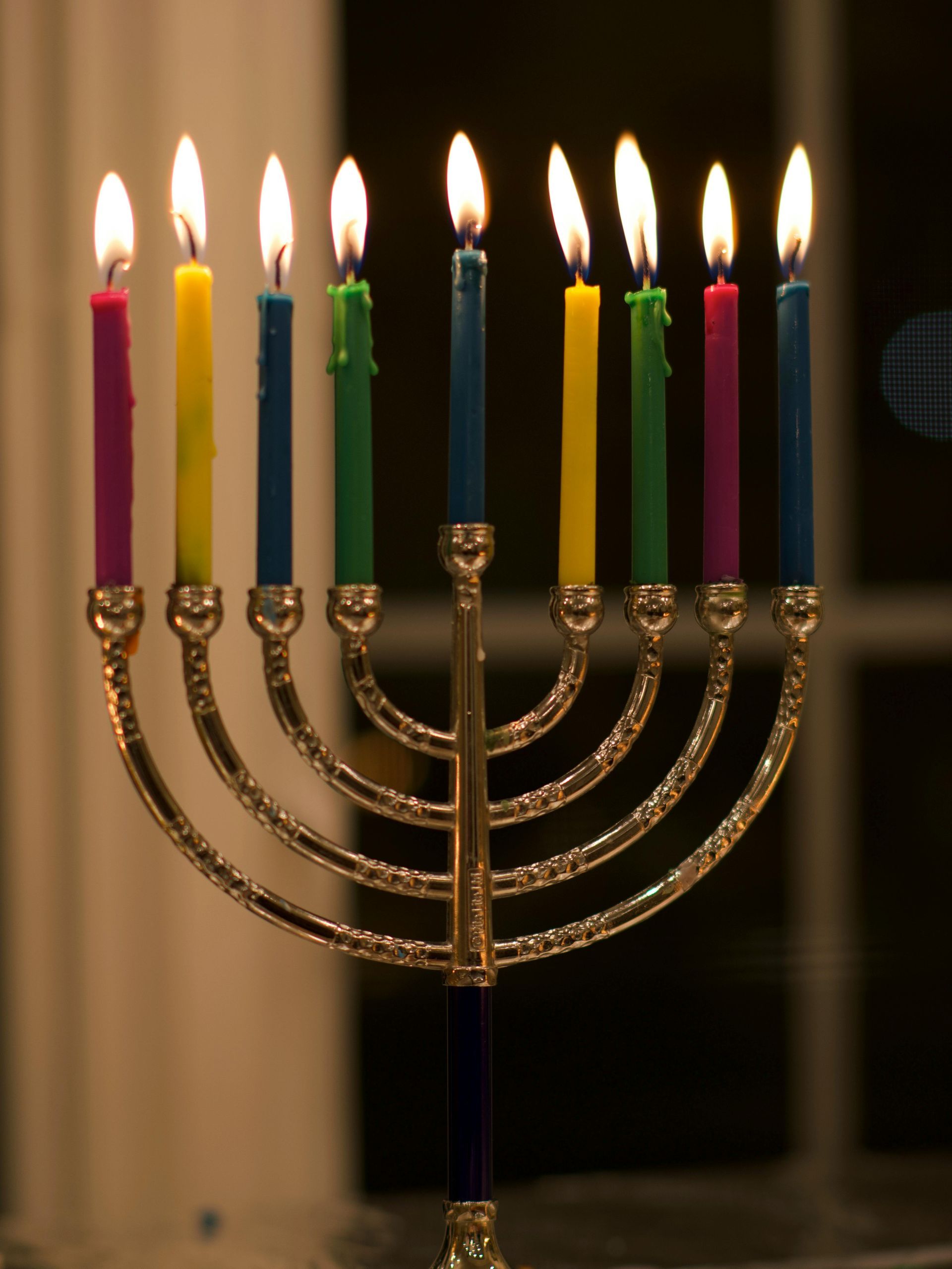 A menorah with a bunch of lit candles on it