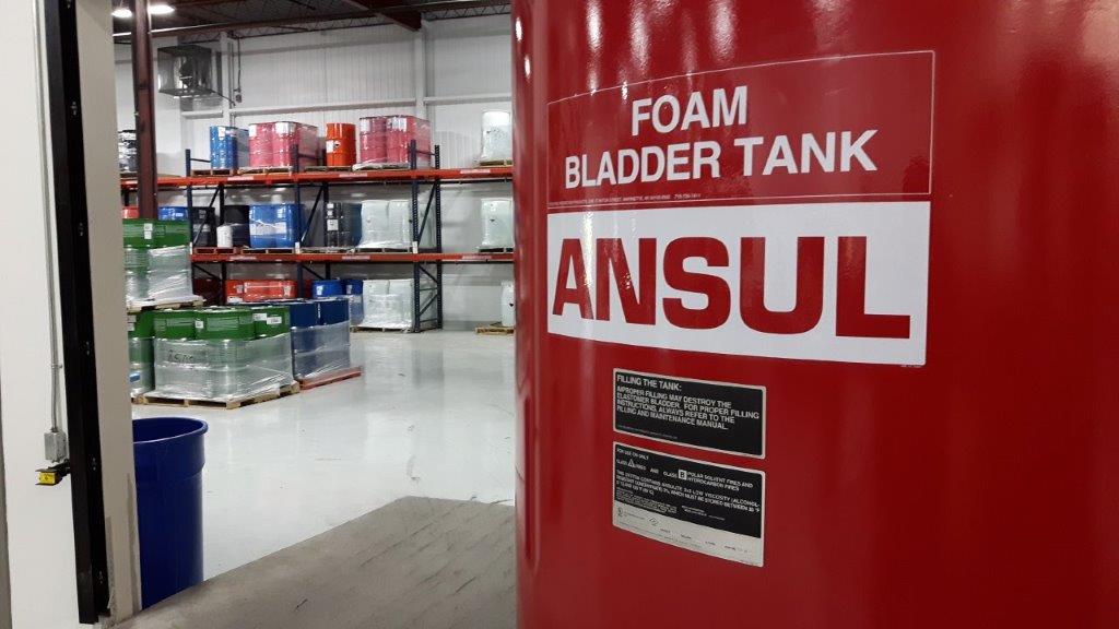 A large red foam bladder tank in a warehouse