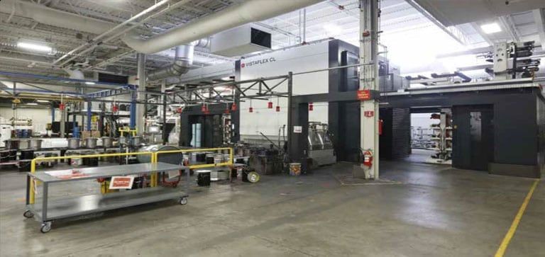 A large warehouse with a lot of machinery in it.