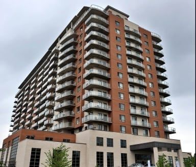 A tall building with a lot of balconies and windows