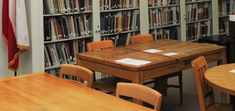 A library with tables and chairs and a flag