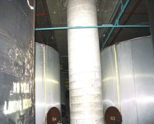 A large concrete pillar is in the middle of a room