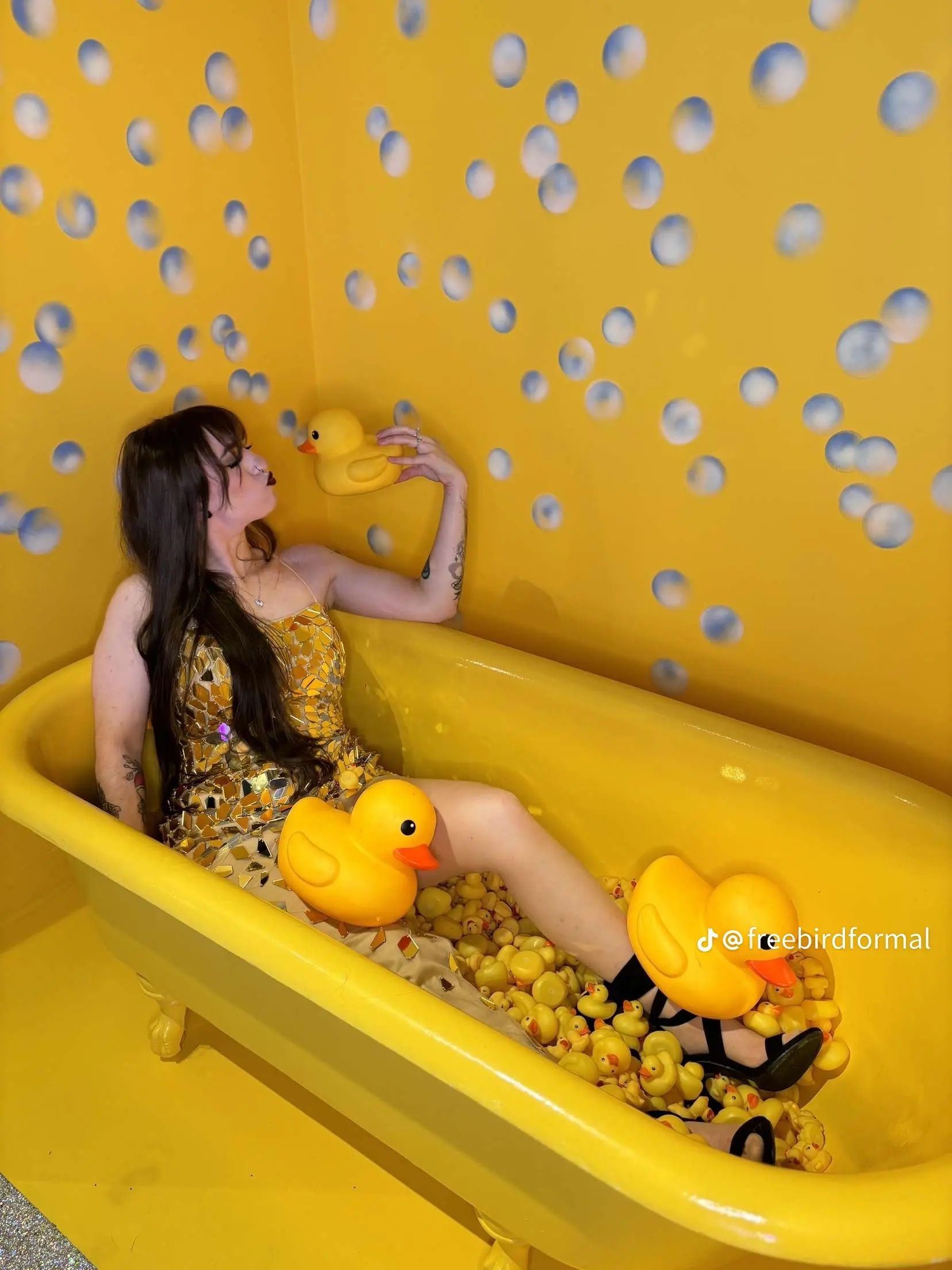 Two women wearing pink and white wigs are posing for a picture.