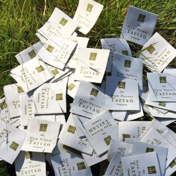 Pile of white fabric tags with