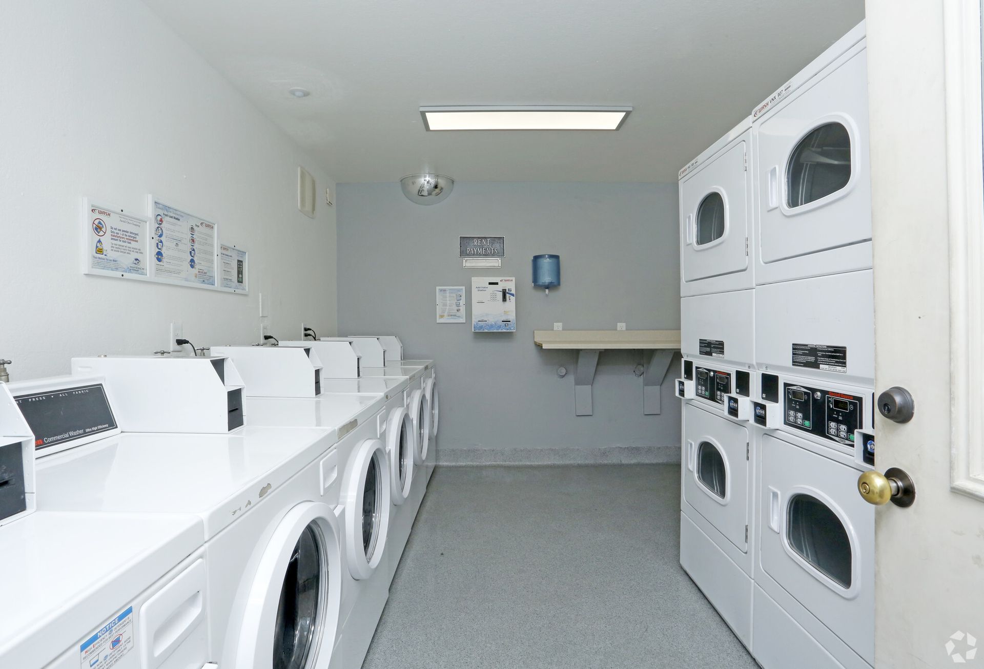 A laundromat with a lot of washers and dryers