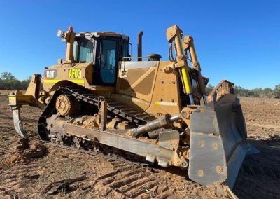 Yellow Caterpillar bulldozer on dirt.