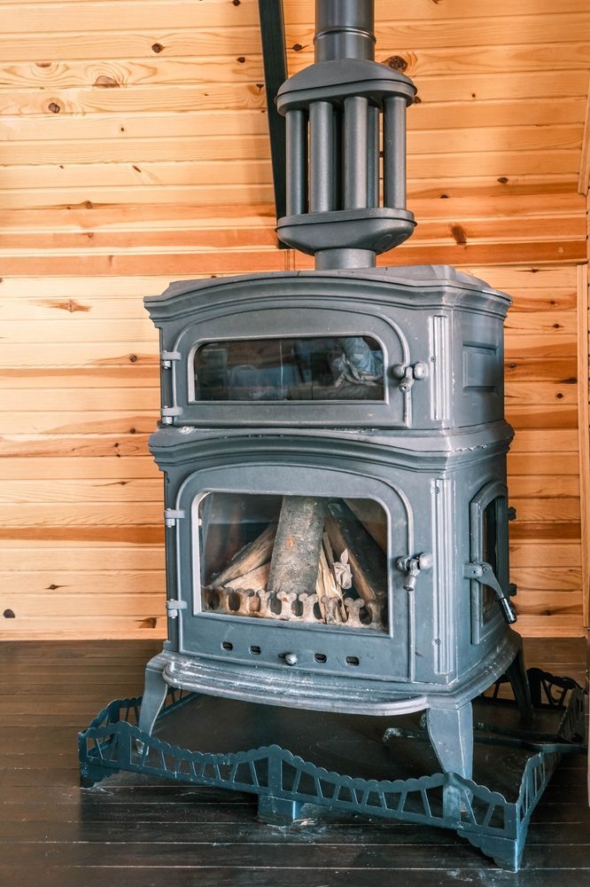 A Cast-iron Wood Stove With a Glass Door — Complete Heating In Huntingfield, TAS