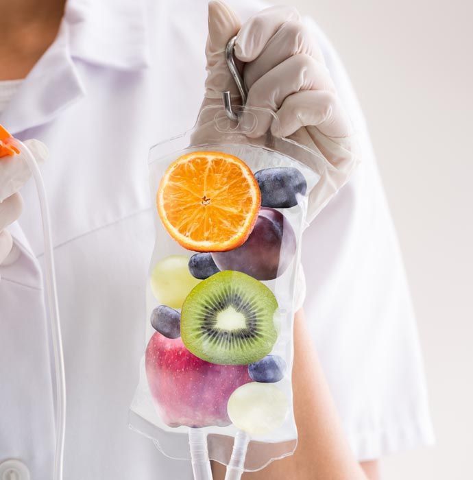 A nurse is holding a bag of fruit in her hand