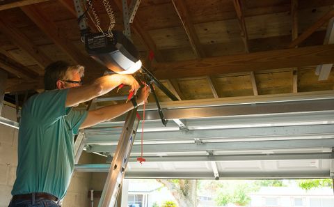Man Repairing Garage Doors — Dallas, GA — Affinity Garage Doors