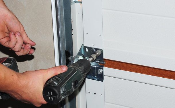 Person Installing Garage Doors — Dallas, GA — Affinity Garage Doors