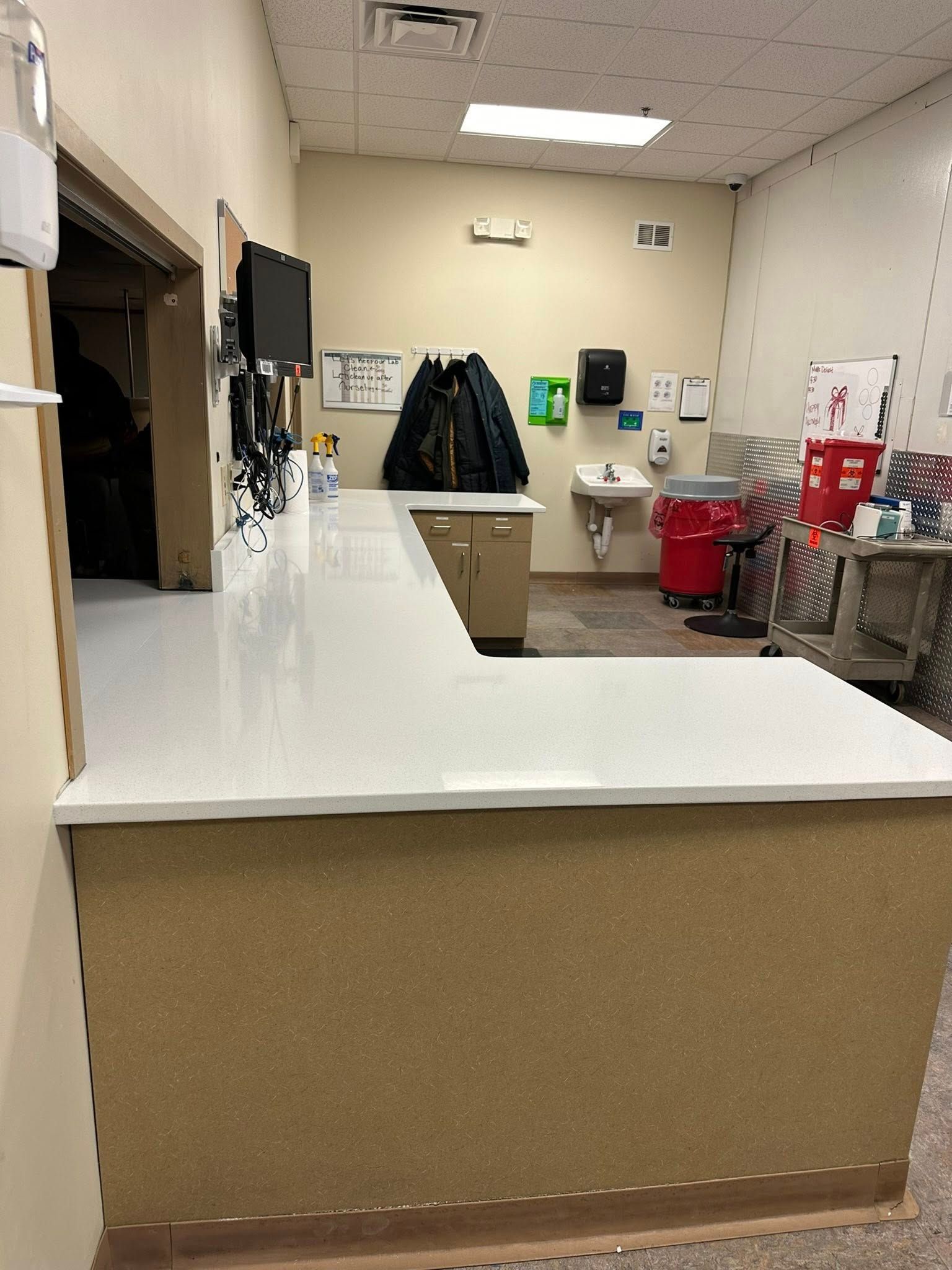 A kitchen with a long counter and a sink.