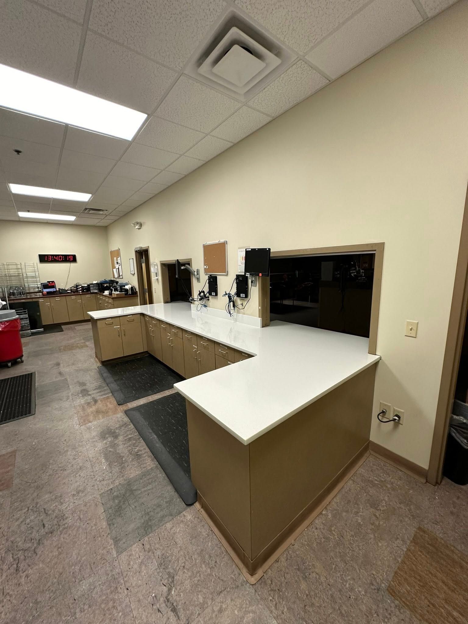 A large room with a counter in the middle of it.