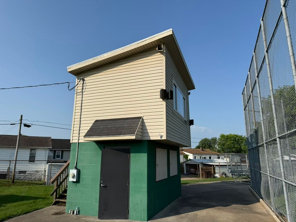 A small green and white building with stairs leading up to it