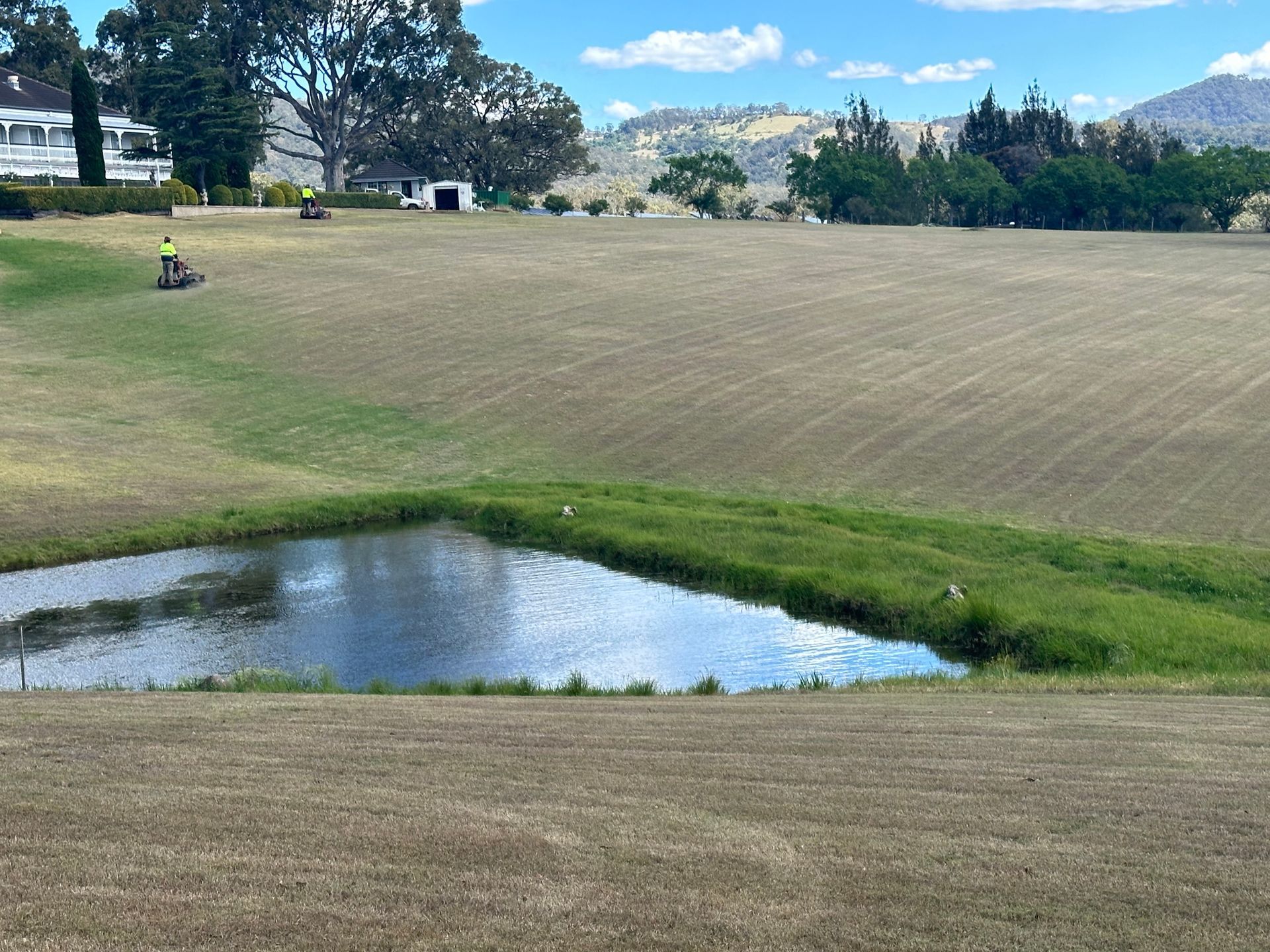 Worker Cutting Grass In The Park By The Lawn Mower — Gardeners In Paterson, NSW