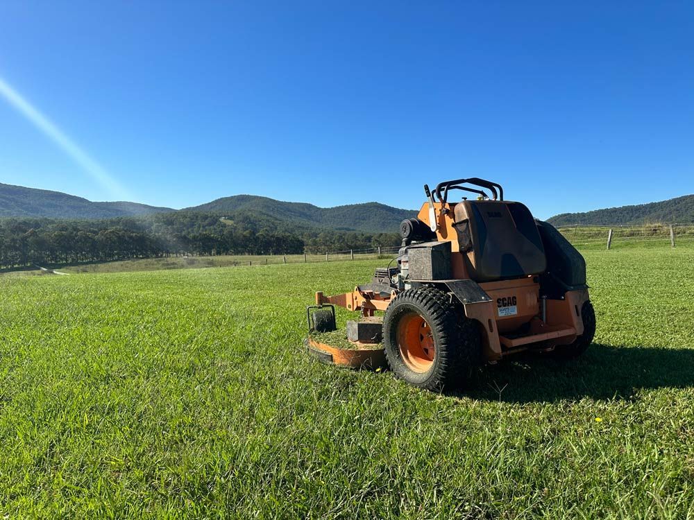 Mowing The Grass With A Lawn Mower — Gardeners In Pokolbin, NSW