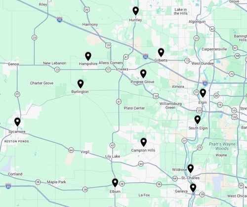 Map with black location pins, showing towns in a green and white area, with roads labeled.