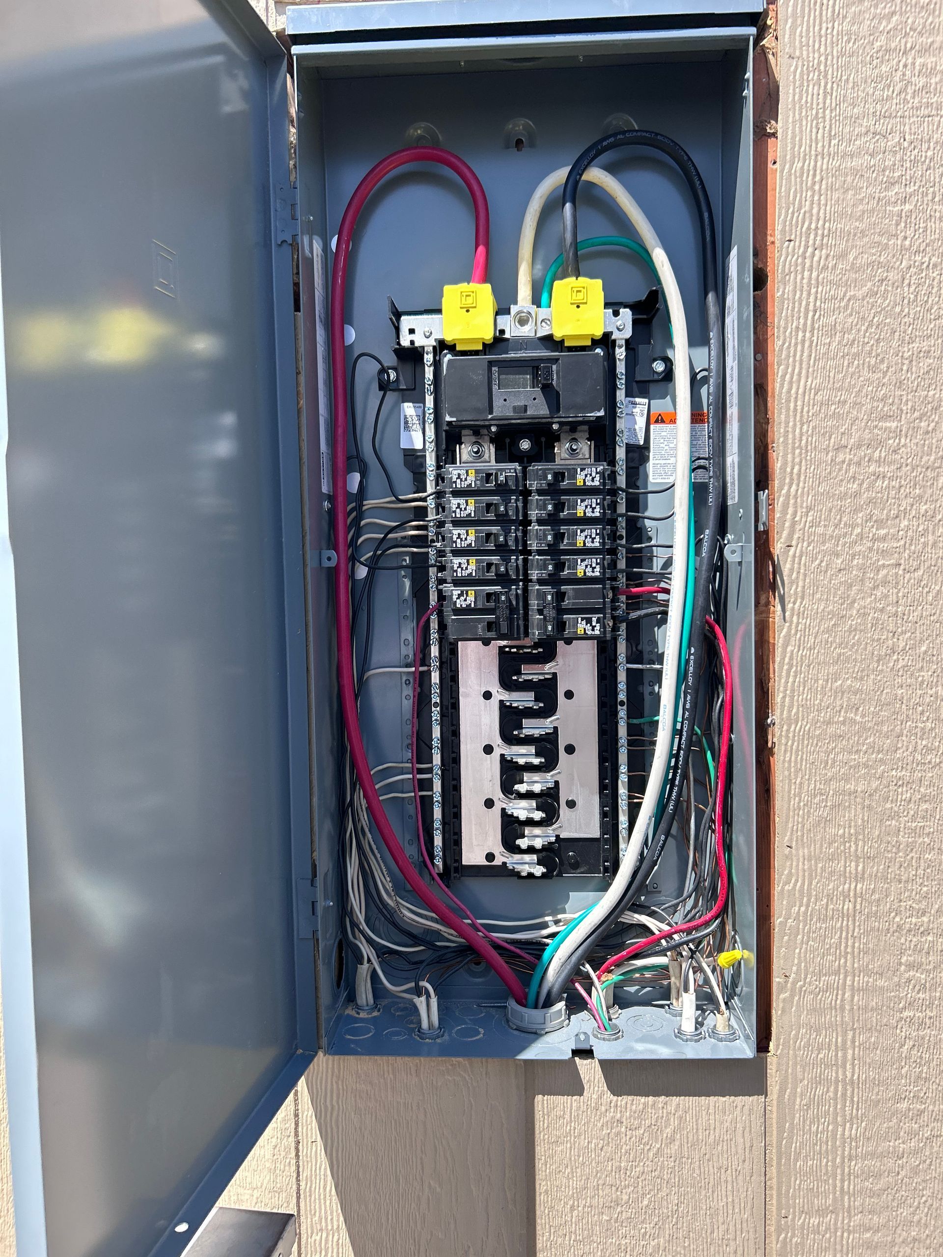 Living room with a fireplace, TV, ceiling fan, and art on the walls. Light brown carpet and neutral walls.