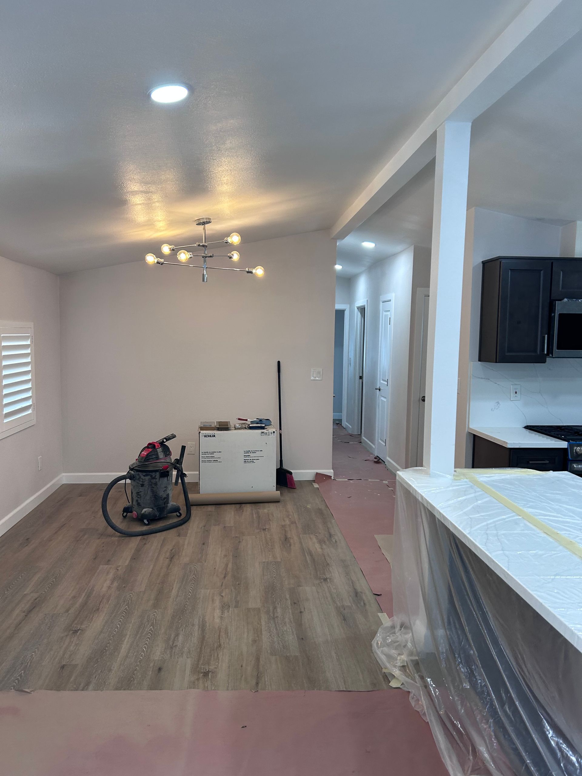 Electrician working on electrical wiring in a wooden structure.