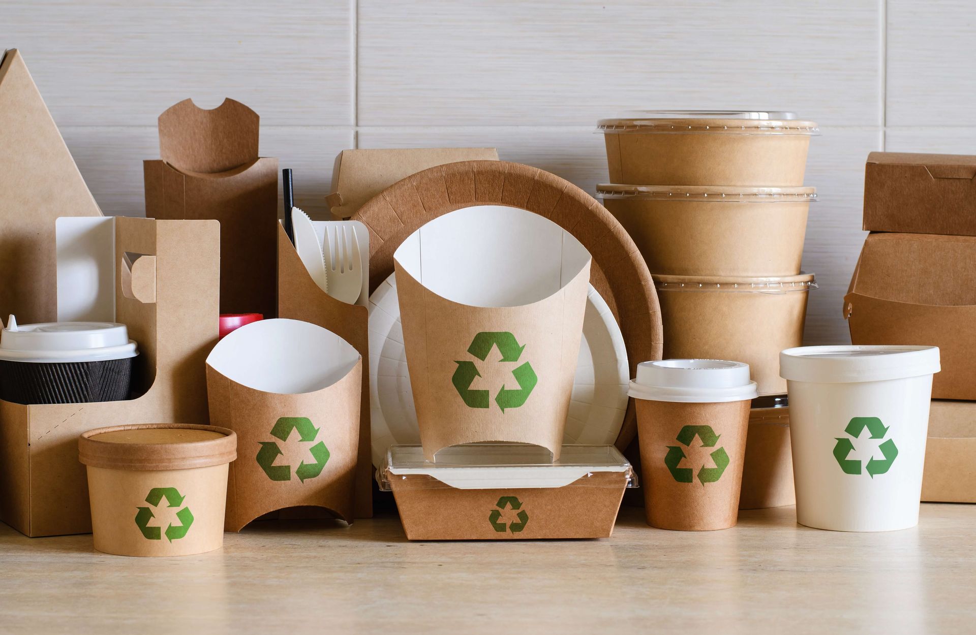 A variety of disposable containers with recycling symbols on them