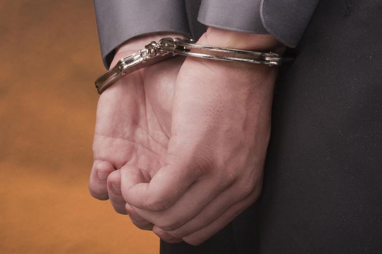 a handcuffs in someone's hand