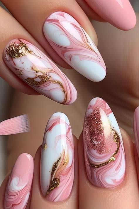 Manicured almond-shaped nails featuring pink and white marble patterns, accents of gold glitter, and solid pink polish.
