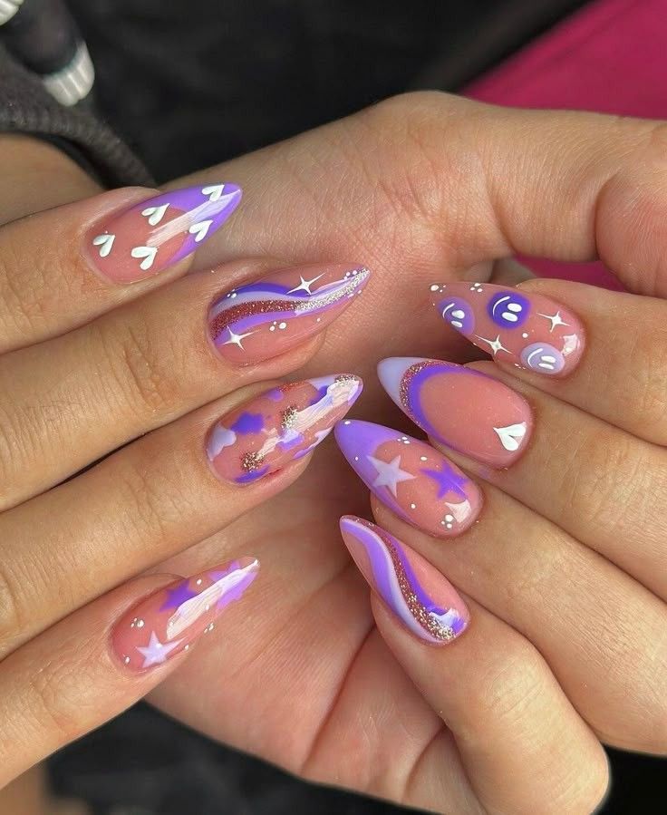 Almond-shaped nails featuring purple and nude designs including swirls, glitter, stars, and smiley faces.