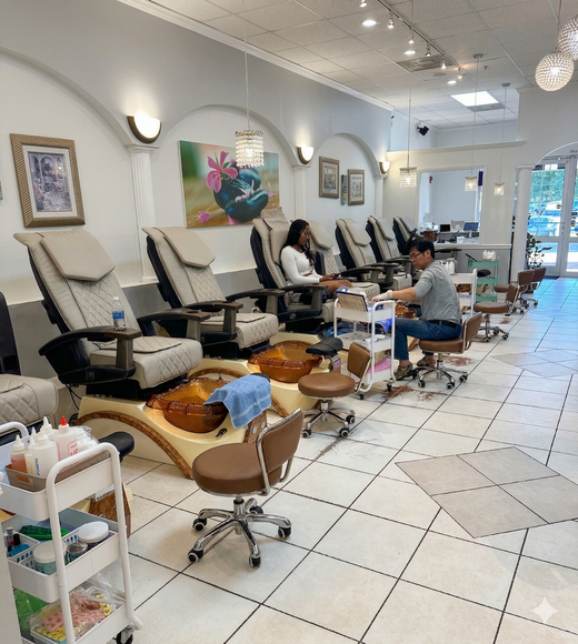A pair of hands with almond-shaped nails featuring a mix of pastel gradients, swirl designs, and purple glitter accents.