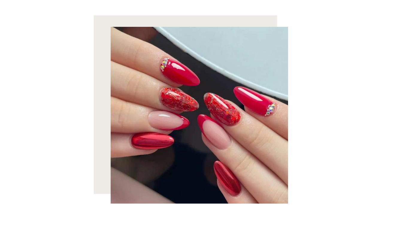 Close-up of hands with long, almond-shaped nails featuring a mix of solid red polish, glitter, and French tip designs.