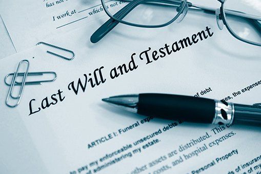 A pen is sitting on top of a last will and testament