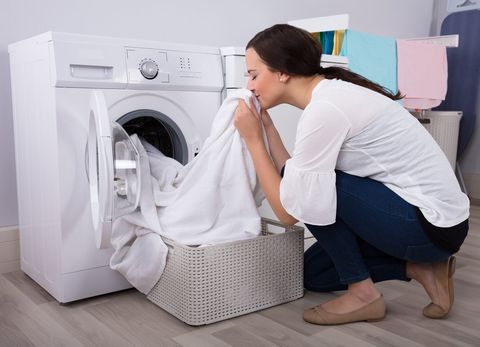 Woman Smelling Her Newly Washed Cloth — Sarasota County, FL — Amerovent Dryer Vent Cleaning Specialists