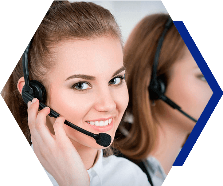 A woman wearing a headset is smiling in a call center.