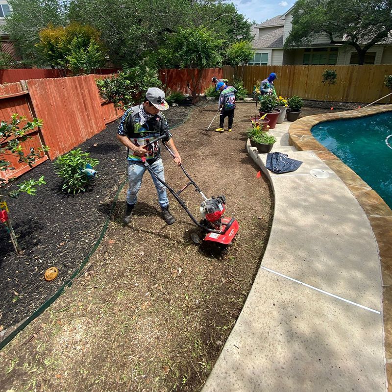 A group of people are working in a backyard next to a pool.