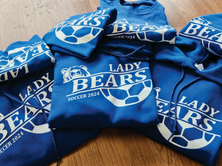 A bunch of lady bears sweatshirts are stacked on top of each other