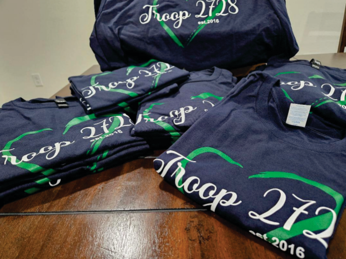 A bunch of t-shirts with the word troop on them