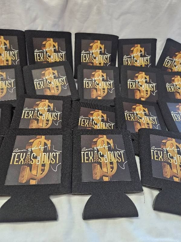 A bunch of can holders that say texas dust