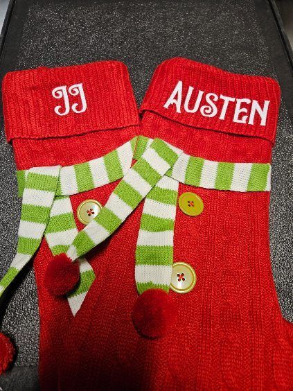 A pair of christmas stockings with the name austen on them