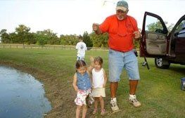 Happy family near lake | Spanish Fort, AL | Gafford Roofing Repair