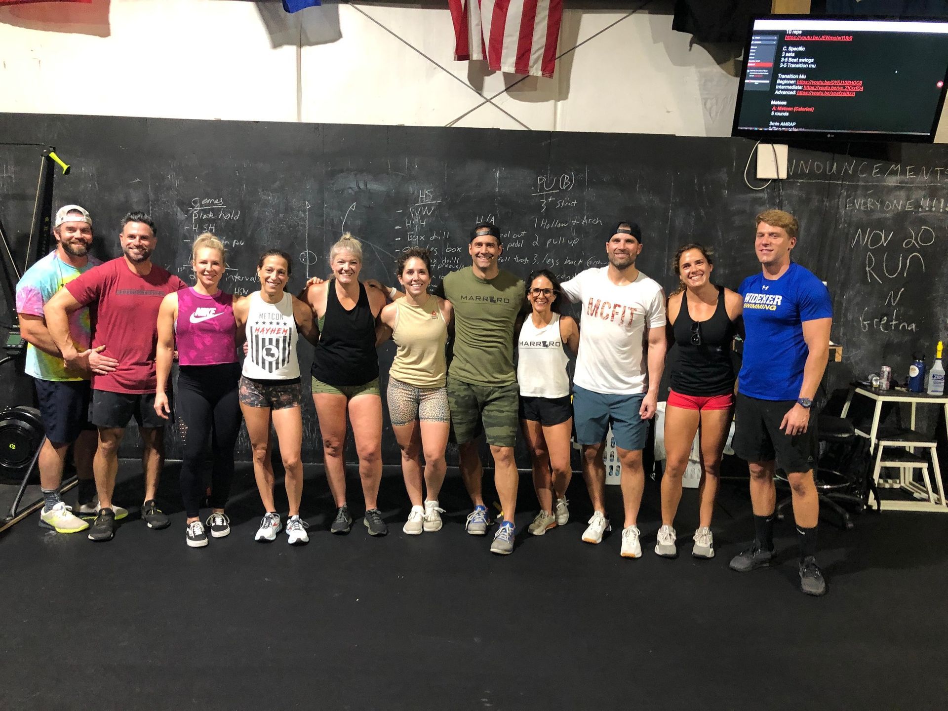 A group of people are posing for a picture in a gym.